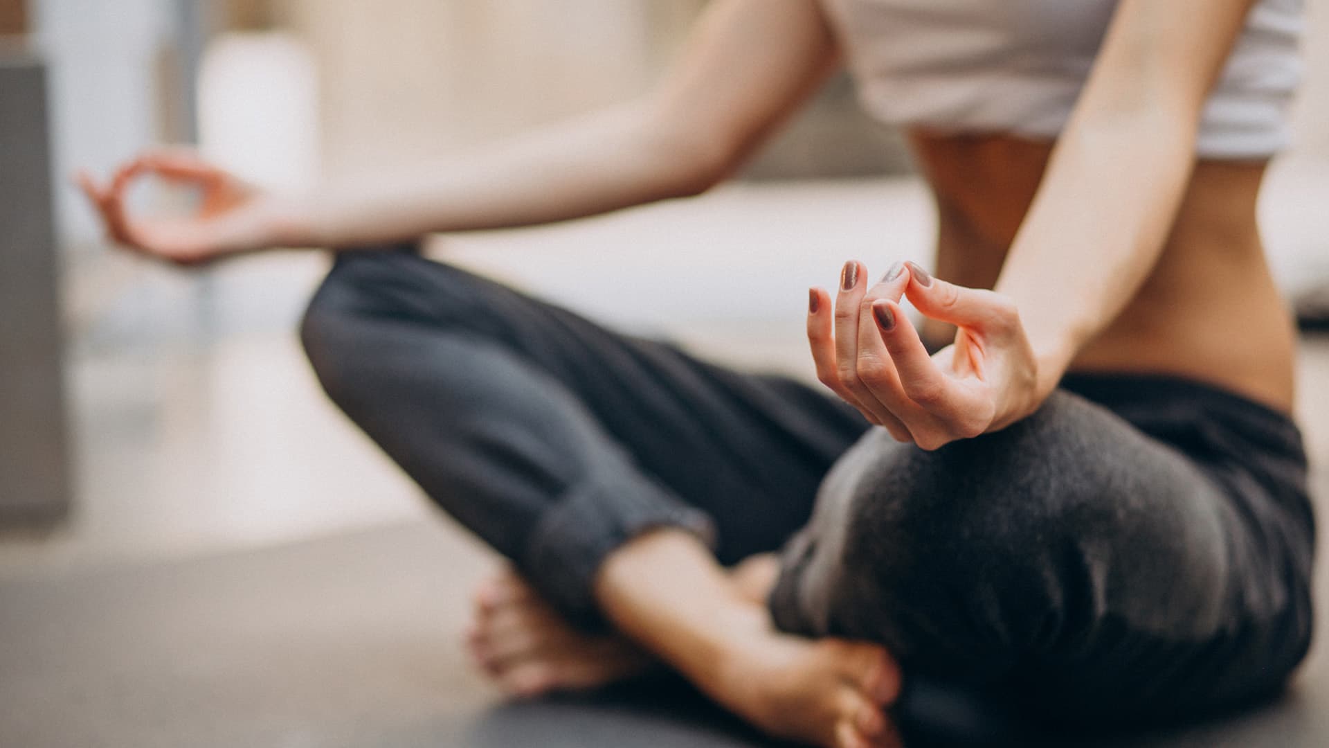 Young woman practicing yoga at home